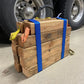 Stack of wooden blocks secured with blue straps featuring Cribbing Strap Long-FFCS12