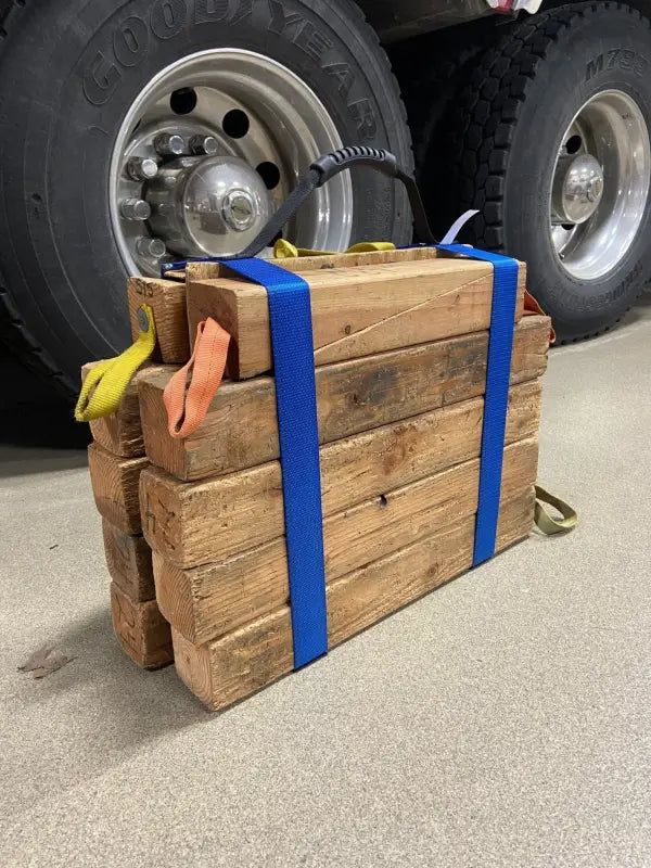 Stack of wooden blocks secured with blue straps featuring Cribbing Strap Long-FFCS12