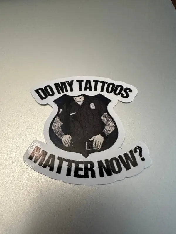 Sticker of tattooed police figure asking if tattoos matter for first responders