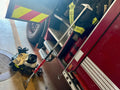 Red fire truck with emergency tools highlighting Stitch Hook and spade tip features