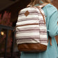 Striped ECHO EDC Backpack with brown leather bottom panel and trim for concealed carry