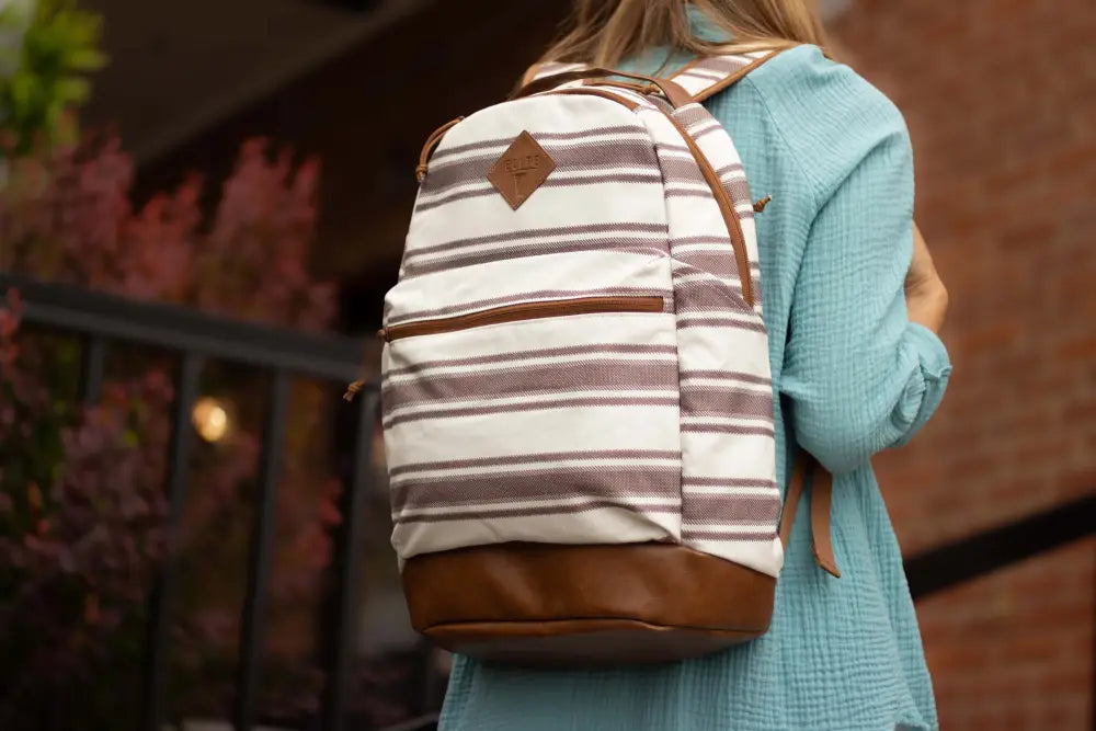 Striped ECHO EDC Backpack with brown leather bottom panel and trim for concealed carry