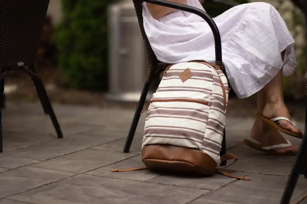 Striped beige and brown Echo EDC Backpack resting on pavement, ideal CCW backpack