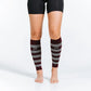 Striped burgundy and gray calf compression sleeves over bare legs with black shorts