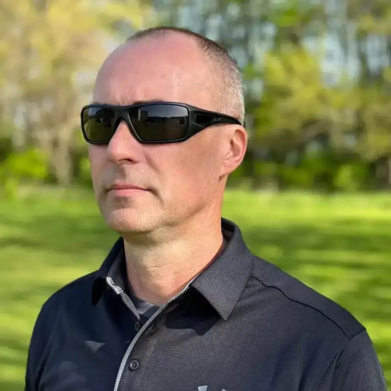 Person wearing METEL M30 Safety Sunglasses with blue mirror lens and dark shirt