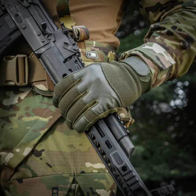 Tactical gloved hand gripping a black assault rifle with M-Tac Gloves Police Gen.2