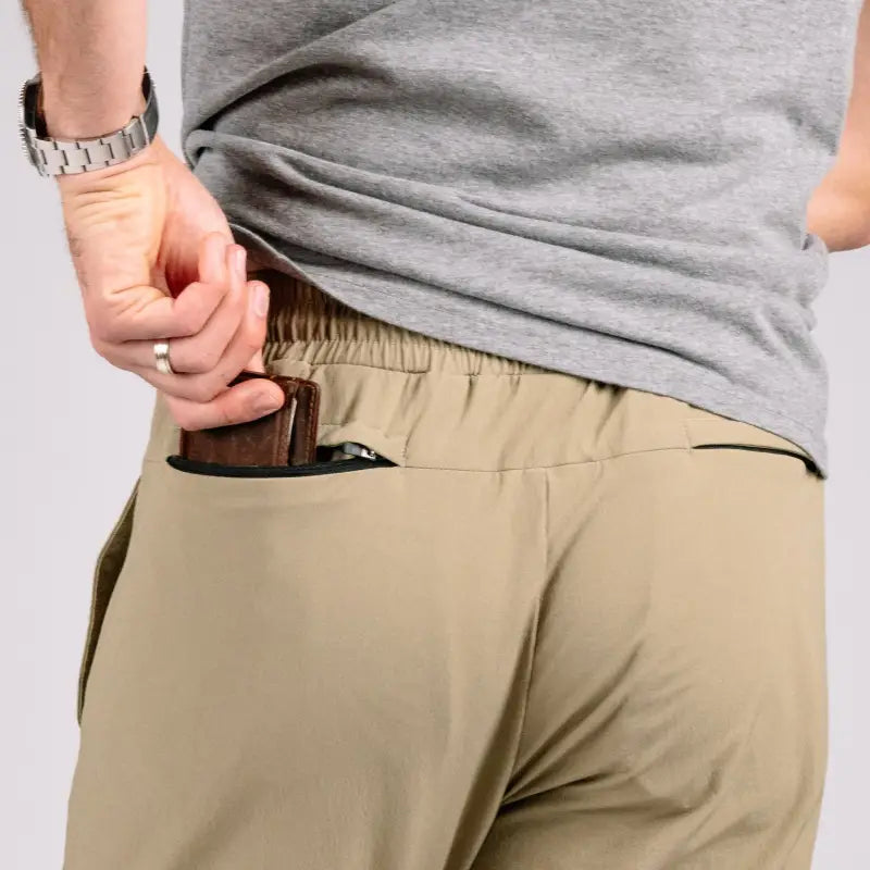 Tan athletic pants with wallet featuring Carrier Traveler Joggers and concealed carry design