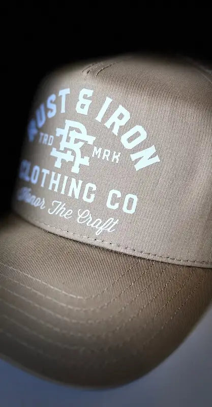 Tan Dirtbag Trucker Hat featuring Rust & Iron Classic Logo embroidery