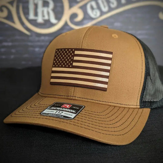 Tan and black baseball cap with American flag patch and leather patch for various head sizes