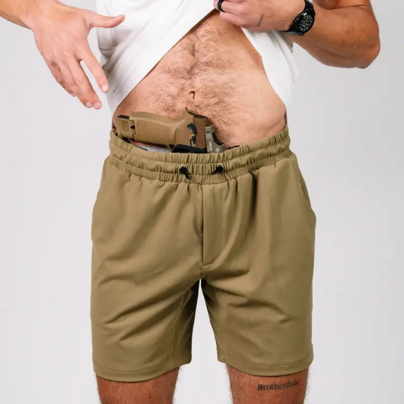 Carrier Shorts Mk.II with concealed carry gun tucked in waistband, arrowhead tactical apparel