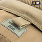 Tan tactical gear label on M-Tac Assault Pack with large main zippered compartments