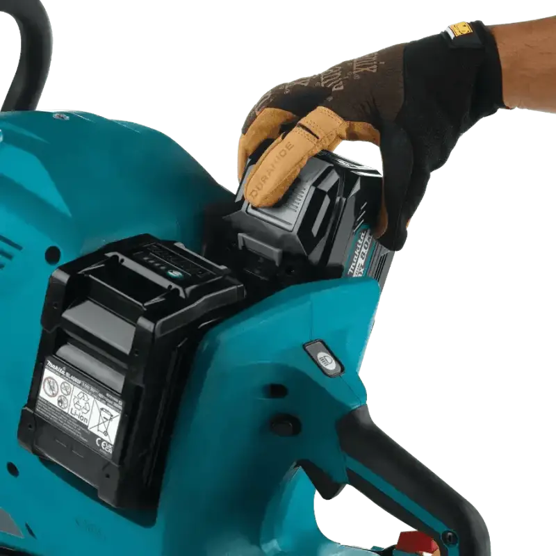 Teal Makita GEC01PL4 80V cordless chainsaw with electric brake and battery in use