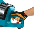 Teal Makita GEC01PL4 80V power tool with electric brake held by a gloved hand