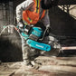 Teal Makita GEC01PL 80V XGT Brushless power cutter slicing concrete with dust spray