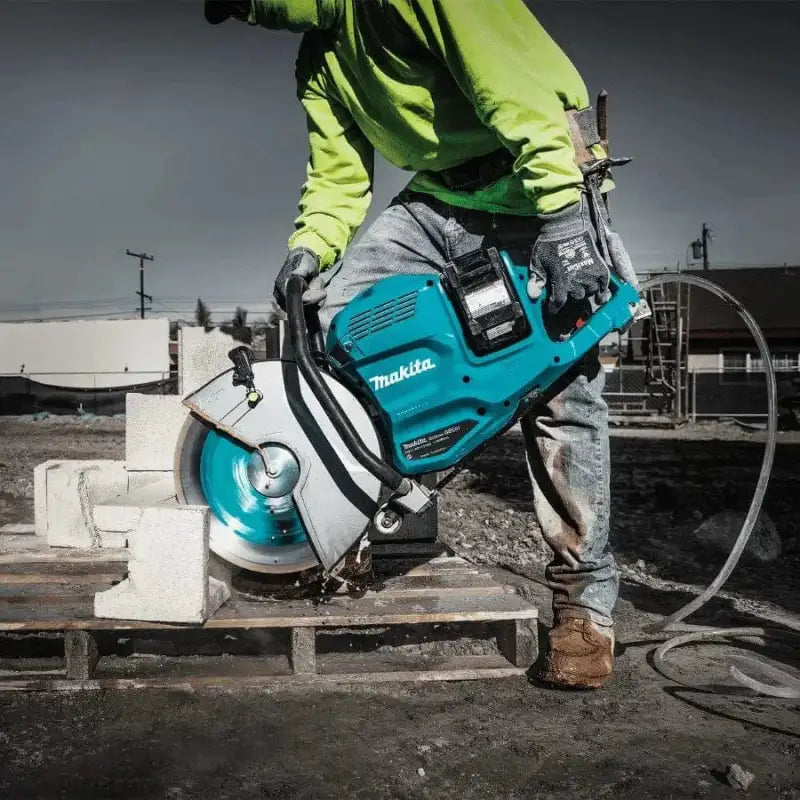 Teal Makita GEC01PL4 80V power tool slicing through concrete with XGT® Brushless technology