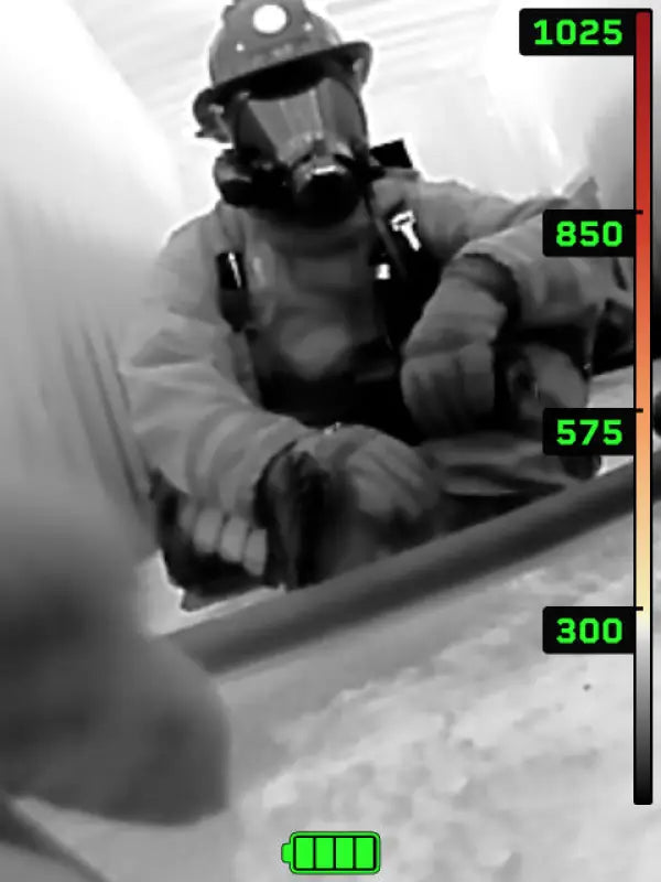 Thermal imaging camera view of a firefighter using Seek FirePRO™ 300 to detect heat signatures