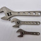 Three adjustable wrenches in descending size, featuring NSN pending titanium design