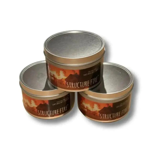 Three metal tins of Structure Flex stacked by Structure Fire Scented Candle for firefighters