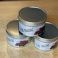 Three stacked metal tins labeled Fire Engine with red truck graphics for scented candle