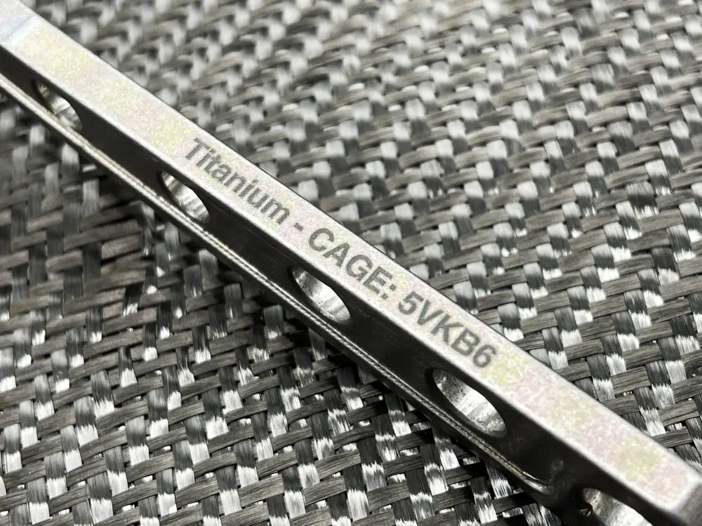 Titanium cage bar with engraved text on textured surface for Adjustable Wrench - Titanium