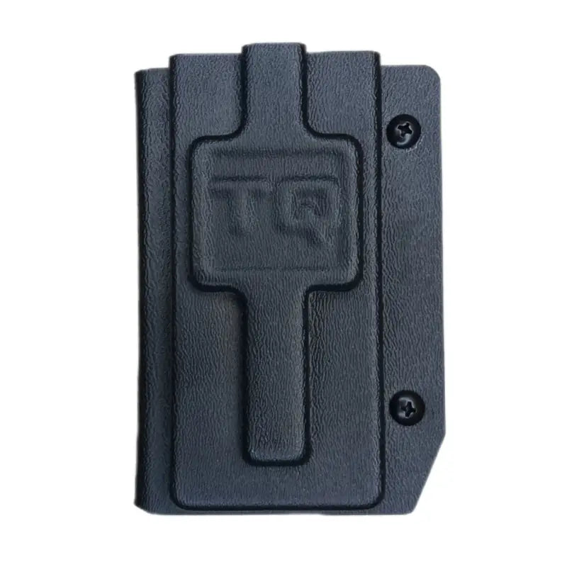 Black plastic Tourniquet Holder with TQ embossed, ideal for first responders in coyote brown