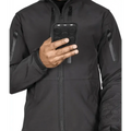 Hand holding a black smartphone in protective case by Tradecraft Tactical Jacket 2.0