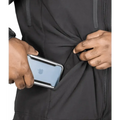 Hands placing an iPhone in a jacket pocket of the Tradecraft Tactical Jacket 2.0