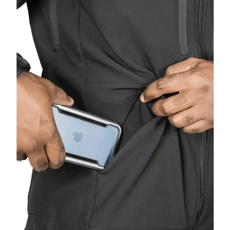 Hands placing an iPhone in a jacket pocket of the Tradecraft Tactical Jacket 2.0