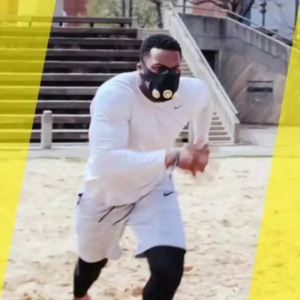 Person in all white Nike gear using TRAINING MASK 2.0 to enhance performance and turn flow