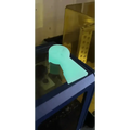 Glowing turquoise keyhole-shaped object in Williams Wedge for first responders and firefighters