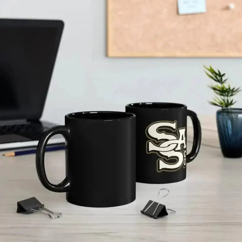 Two black ceramic mugs, one plain and one with SS logo, showcasing the Letter Stack Mug