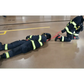 Two firefighters in protective gear using multi-use sewn webbing for safety on the ground