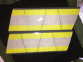 Reflective yellow grey triple stripe panels on Tetrahedron 8 pack helmet