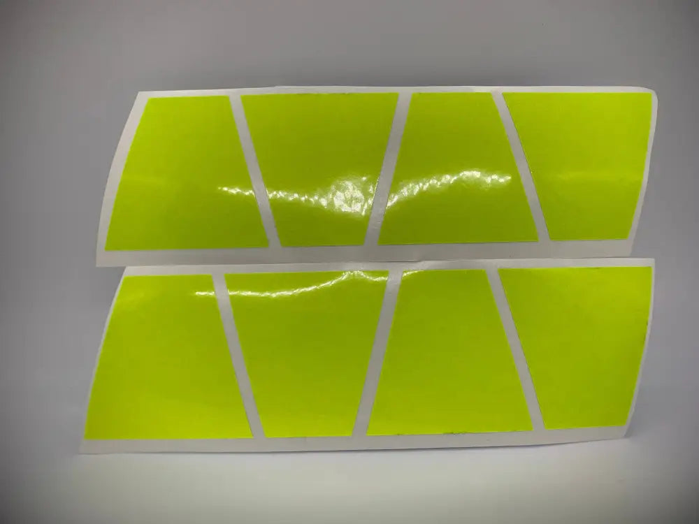 Two rows of retro fluorescent yellow reflective strips on a helmet accessory