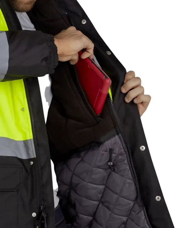 Red wallet being placed in inner pocket of UHV1004 HiVis Contractor Jacket