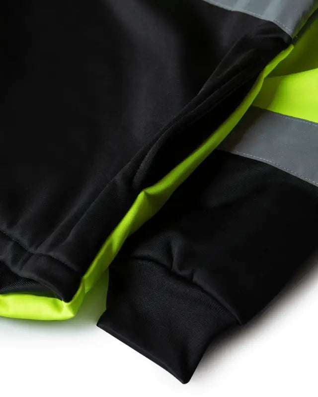 Black athletic pants with neon yellow trim for UHV667 HiVis Women’s quarter zip soft shell