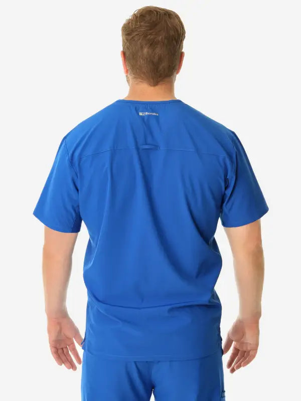 Back view of a person in a bright blue men’s double-pocket scrub top