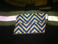 Wallet or clutch featuring a blue and beige chevron reflective pattern