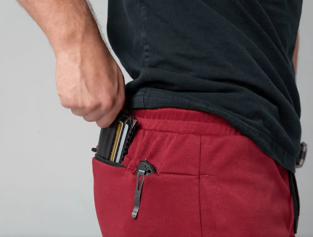 Wallet in a pocket of Carrier Joggers Mk.II - Soldier Red with patented carrier retention