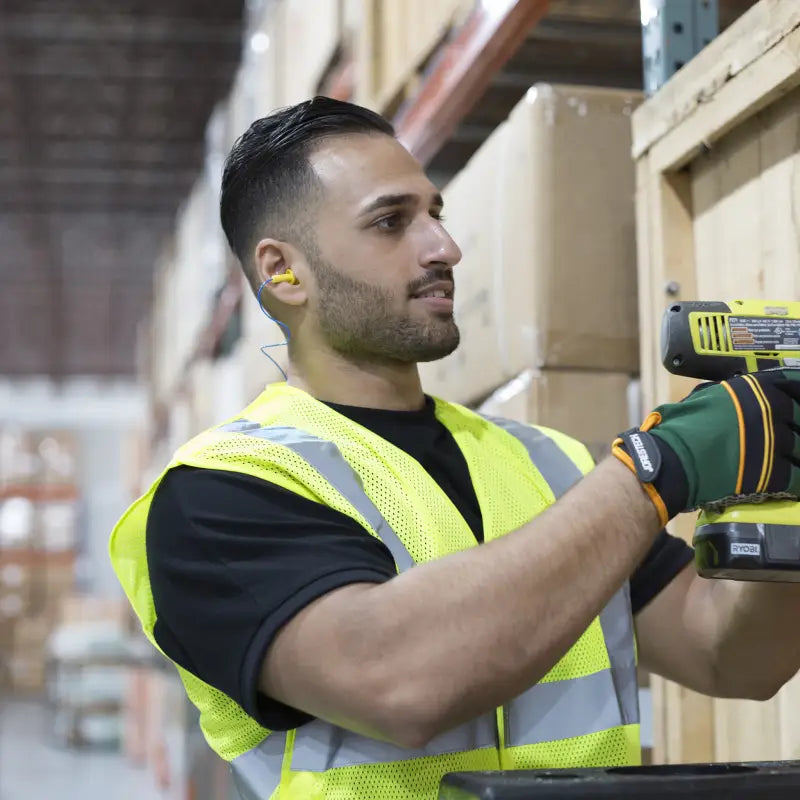 Warehouse worker using silicone tri-flange corded earplugs with flanged design