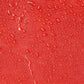 Water droplets on a red surface of the Line2Design Deluxe Step-In Firefighter Gear Bag