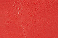 Water droplets on a red surface of a Firefighter Turnout Gear Bag with water resistant outer fabric