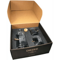 Black gift box with whiskey decanter, rocks glasses, and bar accessories in foam padding