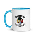White ceramic mug with blue handle featuring text and design about tattoos matter