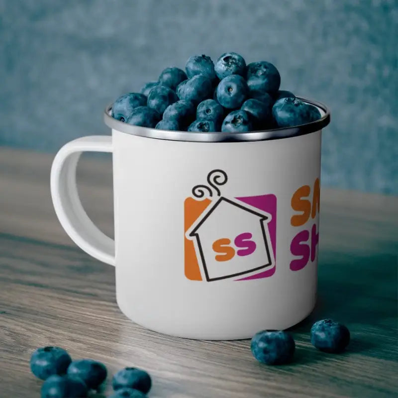 White enamel DD Smoke Showin Camping Mug filled with fresh blueberries and colorful logo