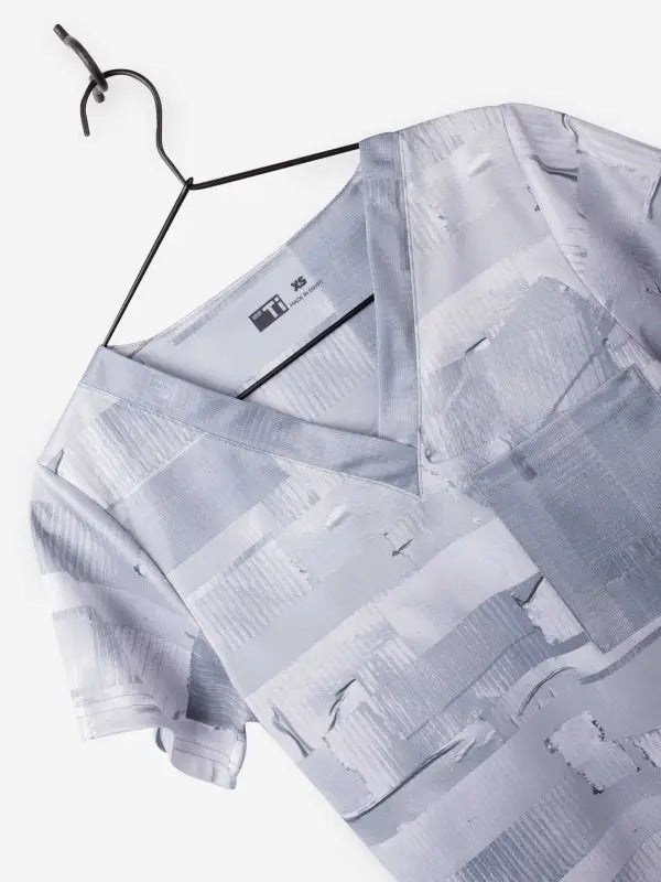 White patterned short-sleeve button-up shirt on a hanger, perfect for Women’s Duct Tape Scrub