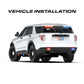 White police SUV with emergency lights featuring Feniex Quantum 2.0 Spoiler Mount for first responders