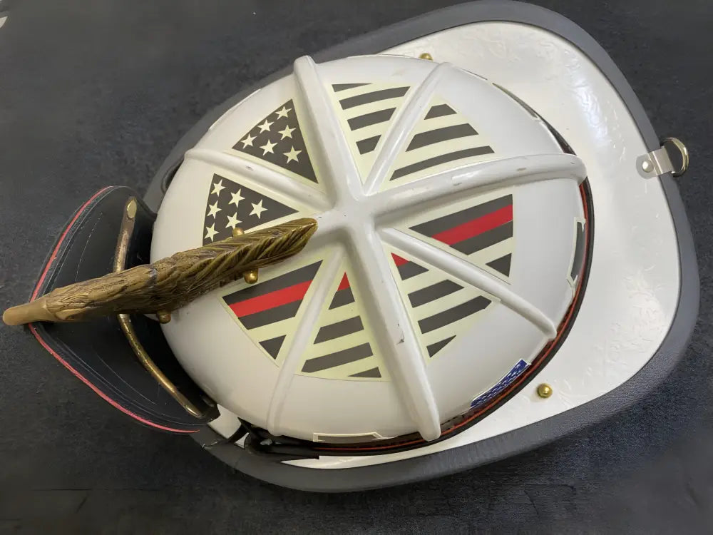 White protective helmet featuring American Flag and Thin Red Line designs for decals