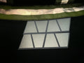 MATTE WHITE REFLECTIVE HELMET casting light and shadows through geometric window panes