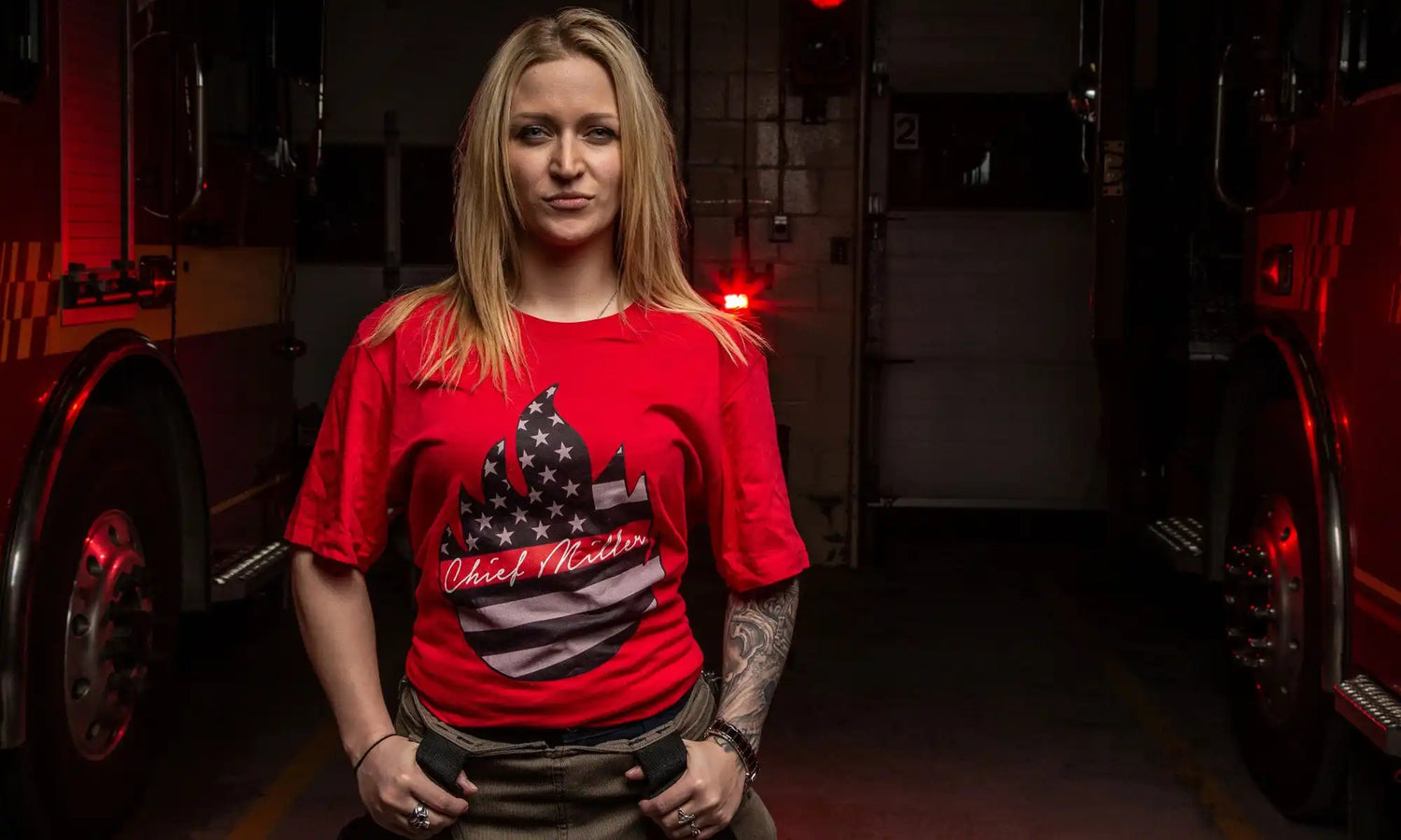 Woman wearing a bright red t-shirt with a graphic design.